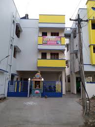 Hostel entrance with security guard and visitors register desk