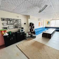 Hostel recreational area with TV, board games, and comfortable seating